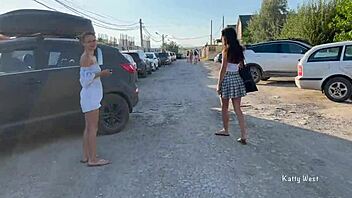Two young women go topless and expose their private parts in a public place