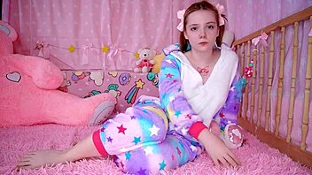 A blonde amateur in anime style wears baby pajamas and plays with her ass