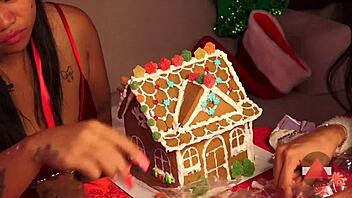 Homemade Christmas fun with two girls building a gingerbread house