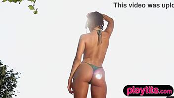 latina beauty strips by the pool