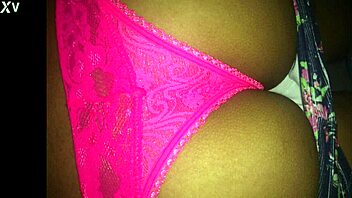 She teases playfully with pink panties, revealing her smooth curves in a flirty display.