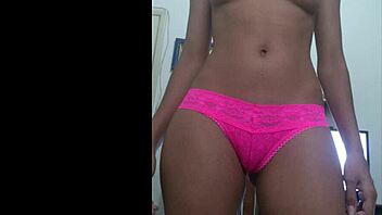 She teases playfully with pink panties, revealing her smooth curves in a flirty display.