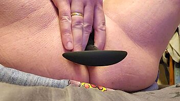 amateur explores deep anal pleasure with extra large plug