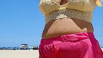 Big-chested African beauty flashes pussy lips on the beach