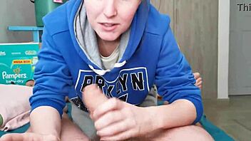 I watch the beautiful brunette in hoodie sucking my huge cock.