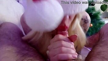 Miss Santa intensely sucks cock under the Christmas tree with her tattooed body