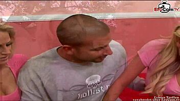 two busty blonde babes enjoy sharing a moment in a group setting