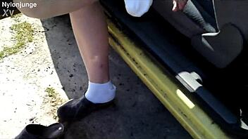 Zeraphine73 shows off her chubby feet in socks while parked outdoors with a friend.