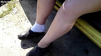 Zeraphine73 shows off her chubby feet in socks while parked outdoors with a friend.