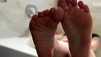 oiled blonde babe shows off her feet in a fetish video