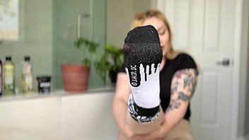 oiled blonde babe shows off her feet in a fetish video