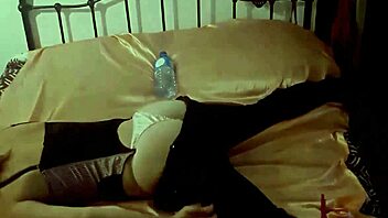 Full blonde amateur in black corset, satin panties, and black leather pants gets doggystyle fucked from behind