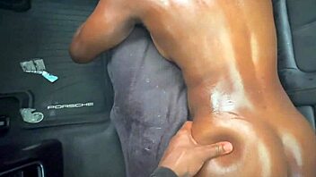 Ebony beauty gets her juicy ass and big tits rubbed with oil