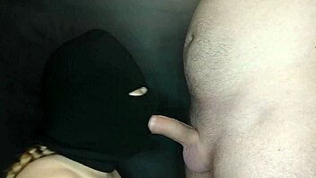 my step sister's hot mouth sucks my cock while her face is hidden by a balaclava. she moans during the sloppy blowjob.