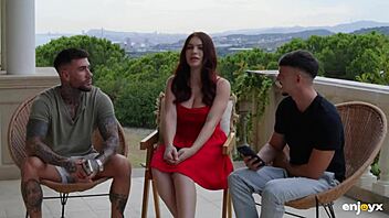 Curvy redhead in lingerie sucks big cocks and rides two young studs, squirting cum on tits.