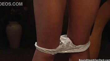 Blonde lesbian slave relishes kissing and groping her dominant madame in bondage