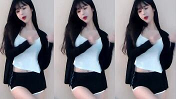 Cute Chinese girl dances wildly in stunning tight outfit