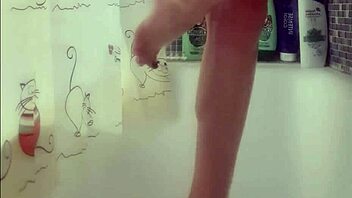 Busty teen washes perfect feet in shower