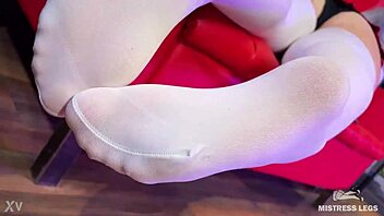 Goddess teases with big booty and feet in white stockings on red couch 😍