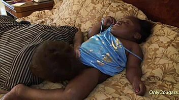 Black midget babe slurps on a white shaft