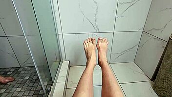 young milf teases with her feet in the bath.