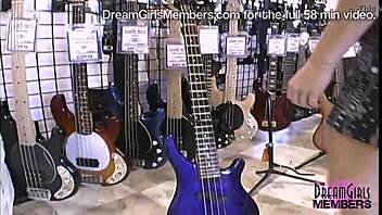 She flashes huge tits and pussy in guitar shop.