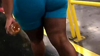 Ebony woman with thick booty walks in leggings, captured candidly on hidden camera.