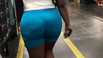Ebony woman with thick booty walks in leggings, captured candidly on hidden camera.