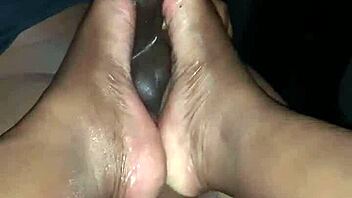 Bold ebony footjob with black feet.