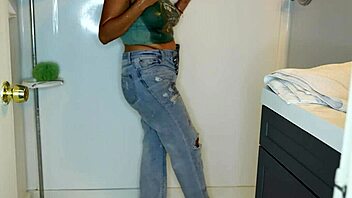 Latina woman wets her jeans and panties before stripping in the shower