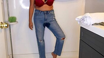 Latina woman wets her jeans and panties before stripping in the shower