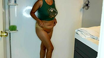 Latina woman wets her jeans and panties before stripping in the shower