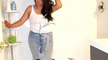 Latina woman wets her jeans and panties before stripping in the shower