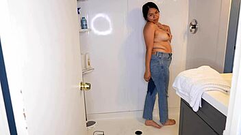 Latina woman wets her jeans and panties before stripping in the shower