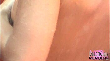 Is this tanned brunette shaving in outdoor shower?