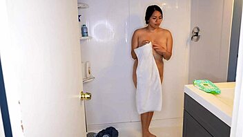 Latina woman wets her jeans and panties before stripping in the shower