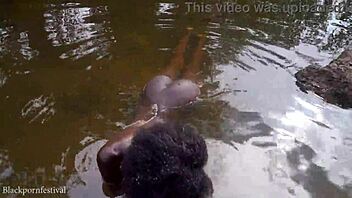 Skinny adorable African girl bathes in the village river