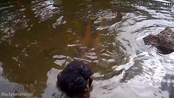 Skinny adorable African girl bathes in the village river