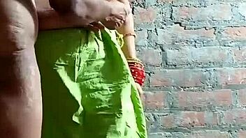 The uncle helps his brother's wife on the bed.