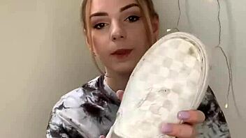 A Serbian girl removes her sneakers to reveal her bare feet.