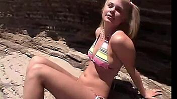 Little summer shares her natural tits and pussy at the beach