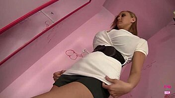 Alexia waits to suck the cock from the hole in the wall.