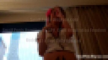 In this POV femdom scene, the mistress dominates her slave by forcing him to show his tiny 18+ cock to three hotties while emphasizing fetish and BDSM elements.