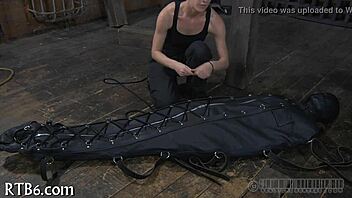 A restrained girl gets punished in the garage