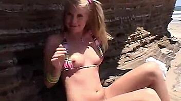 Little summer shares her natural tits and pussy at the beach
