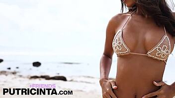 asian babe putri cinta fingering her bum hole at the beach