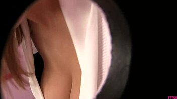 Alexia waits to suck the cock from the hole in the wall.