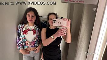 Two horny bitches are kissing in the public locker room with big tits