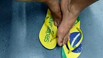 candid brazilian girl playing with flip flops