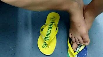 candid brazilian girl playing with flip flops